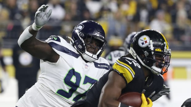 Seattle Seahawks defensive tackle Poona Ford (97) chases Pittsburgh Steelers running back Najee Harris (22) during the first quarter at Heinz Field.